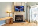 Close-up on the fireplace with a decorative mantel and a large window to the right at 1062 Glen Chase Dr, Lawrenceville, GA 30044