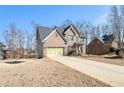 Lovely brick two-story home with a two-car garage and front lawn in a residential neighborhood at 145 Windward Hls, Mcdonough, GA 30253