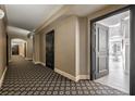 Hallway features patterned carpeting and stylish black doors at 75 14Th St # 4140, Atlanta, GA 30309