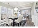 Elegant dining area boasting stylish lighting, wainscoting and large windows at 885 Clairidge Ln, Lawrenceville, GA 30046