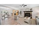 Bright living room with fireplace, wood floors, and open access to the kitchen and dining area at 1131 Mayfield Dr, Decatur, GA 30033