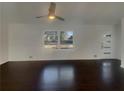Minimalist living room featuring dark wood floors, a ceiling fan and large window at 2217 Troutdale Dr, Decatur, GA 30032