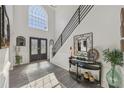 Bright foyer with high ceilings, large arched window, and decorative furnishings at 2755 Turning Leaf Dr, Lawrenceville, GA 30044