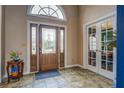 Welcoming foyer features tiled flooring and a decorative glass front door at 9235 Heatherton Walk, Duluth, GA 30097