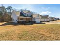 Wide view of a craftsman style home displaying the architectural details, lawn and surrounding neighborhood at 188 Harmony Woods Dr, Dallas, GA 30157