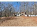 View of the front of a beautiful stone accented home with a welcoming front yard and white picket fence at 332 Stonecutters Cv, Stockbridge, GA 30281