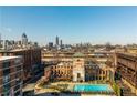 Aerial view of community buildings, pool, and the Atlanta skyline at 170 Boulevard Se # 111H, Atlanta, GA 30312