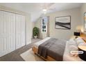 Cozy bedroom with plush carpet, a large window, a ceiling fan, and a closet for ample storage at 1740 Berry Ct, Cumming, GA 30041