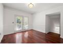 Dining room featuring hardwood floors, neutral walls, classic trim, and doors to a balcony at 2700 Pine Tree Ne Rd # 3010, Atlanta, GA 30324