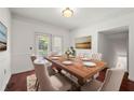 Bright dining room featuring hardwood floors, neutral walls, classic trim, and views of the outdoors at 2700 Pine Tree Ne Rd # 3010, Atlanta, GA 30324