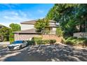 Back of the townhome with view of back porch, parking space, greenery, and brick facade at 2700 Pine Tree Ne Rd # 3010, Atlanta, GA 30324