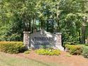 Stonepark private residence sign with manicured landscaping and colorful flowers at 3020 Wingate Way, Sandy Springs, GA 30350