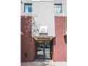 Building entrance featuring brick facade, frosted glass doors, and a modern sign with the address at 335 W Ponce De Leon Ave # 506, Decatur, GA 30030