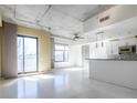 Bright living room features concrete ceiling, expansive windows, and an open floor plan at 335 W Ponce De Leon Ave # 506, Decatur, GA 30030