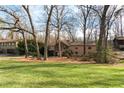 Lovely home featuring a stone facade and manicured lawn, surrounded by mature trees providing ample shade at 3640 Shelby Ln, Marietta, GA 30062