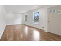 Bright living room with freshly painted white walls, hardwood floors, and natural light from large windows at 4169 Cedar Valley Ln, Conley, GA 30288