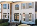 Elegant home entrance featuring stone steps and detailed trim at 2038 Cresthaven Walk, Woodstock, GA 30189