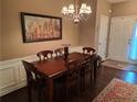 Elegant dining room featuring a chandelier, hardwood floors, and a large dining table at 215 Kigian Trl, Woodstock, GA 30188