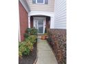 Inviting front entrance with decorative plants and sidelight, perfect for welcoming guests at 215 Kigian Trl, Woodstock, GA 30188