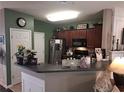 Cozy kitchen with stainless steel appliances, dark cabinets, and a breakfast bar at 215 Kigian Trl, Woodstock, GA 30188