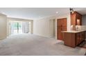 Open living space features plush carpet, neutral walls, and access to a private balcony through sliding glass doors at 25309 Plantation Ne Dr # 309, Atlanta, GA 30324