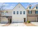 Well-maintained townhouse exterior featuring a two-car garage, brick accents, and modern design elements at 2978 Edgemont Ln, Marietta, GA 30008