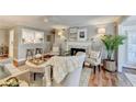 Cozy living space featuring a fireplace, comfortable seating, and views into the kitchen at 309 Berkeley Woods Dr, Duluth, GA 30096