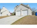 Exterior view of home featuring a two-car garage and long driveway at 7282 Williamsburg Dr, Riverdale, GA 30274