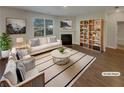 Bright, virtually staged living room with a fireplace, bookshelf, stylish furniture, and lots of natural light at 8120 Berrywood Ct, Covington, GA 30014