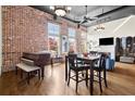 Bright, open living room with brick wall, high ceilings, hardwood floors, and piano at 1459 Village Park Ct, Atlanta, GA 30319