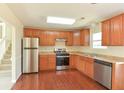 Bright kitchen with stainless steel appliances, wood floors, and ample cabinet space at 1614 Carrie Farm Ct, Kennesaw, GA 30144
