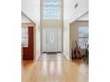Grand foyer with soaring ceilings, tile flooring, and abundant natural light streaming through the front door's transom window at 3308 Hunting Creek Pass, Douglasville, GA 30135
