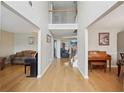 Spacious hallway with wood floors, decorative wall art, and clear sightlines to various living spaces in the home at 3308 Hunting Creek Pass, Douglasville, GA 30135