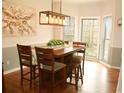 Bright dining room with hardwood floors, bay window, and modern lighting fixture at 3527 Kellogg Creek Rd, Acworth, GA 30102