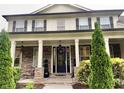 Charming front entrance with stone accents, black door, and decorative plants framing the entryway at 140 Discovery Lake Dr, Fayetteville, GA 30215