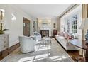 Bright living room with fireplace, neutral decor, and large windows at 3114 Peachtree Ne Dr, Atlanta, GA 30305