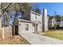 Side view of home showing driveway, lawn, and neutral siding at 6218 Creekford Ln, Lithonia, GA 30058