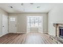 Bright living room boasts wood floors, a bay window, and a cozy stone fireplace at 2419 Leslie Brook Dr, Decatur, GA 30035