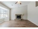 Spacious living room features hardwood floors, a stone fireplace, and a large window at 2419 Leslie Brook Dr, Decatur, GA 30035