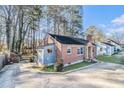 Well-maintained brick house with a spacious yard, mature trees, and extended side addition at 4809 Lavista Rd, Tucker, GA 30084