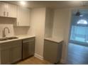 Efficient kitchen features white cabinets, modern sink and new stainless steel dishwasher at 5611 Executive Way, Norcross, GA 30071