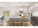 Modern kitchen with stainless steel appliances, large island, and bar stool seating at 9460 Cedar Grove Ct # 329, Jonesboro, GA 30238