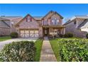 Well-maintained brick home features a symmetrical facade, green lawn, and attached two-car garage at 120 Daniel Creek Ln, Sugar Hill, GA 30518