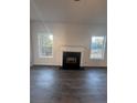 Inviting living room featuring a fireplace with white mantle, neutral paint, and plenty of natural light at 2878 Belfaire Lake Dr, Dacula, GA 30019