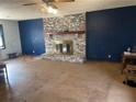 Spacious living room with a brick fireplace, wood mantel, and paneled walls at 420 Lee Dr, Acworth, GA 30102