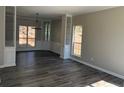 Dining room with hardwood floors, display shelving, and natural lighting at 6910 Stone Breeze Dr, Stone Mountain, GA 30087