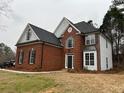 Exterior showcasing brick and siding details with well-maintained landscaping at 6910 Stone Breeze Dr, Stone Mountain, GA 30087