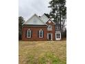 Two story brick and siding home with a gray roof and black shutters at 6910 Stone Breeze Dr, Stone Mountain, GA 30087