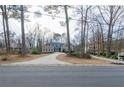 Picture of a lovely home, flanked by beautiful trees and a well maintained lawn at 814 Oak Moss Dr, Lawrenceville, GA 30043