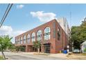 Brick building with arched windows and 'Pullman Flats' signage, showcasing its architectural detail and street presence at 112 Rogers Ne St # 206, Atlanta, GA 30317